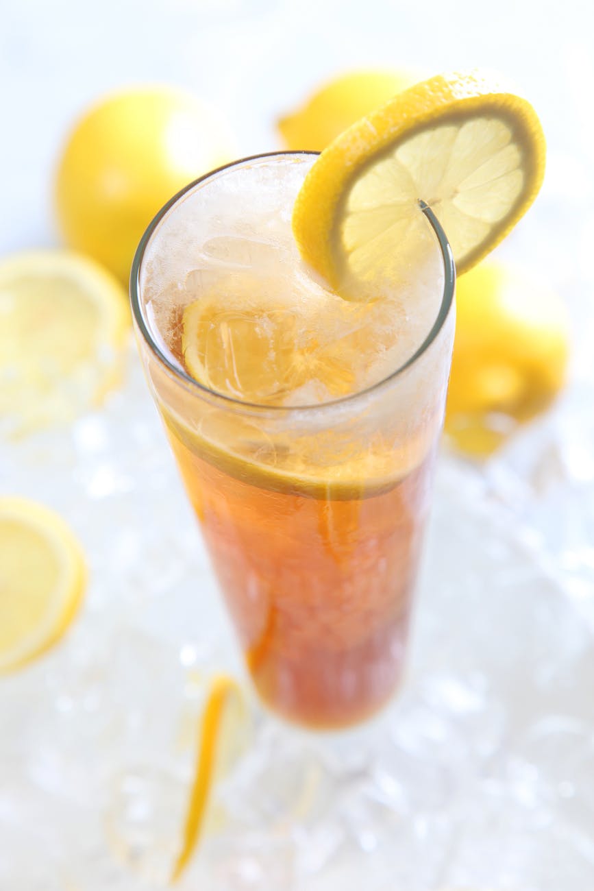 cold drinks served on clear highball glass with lemon garnish