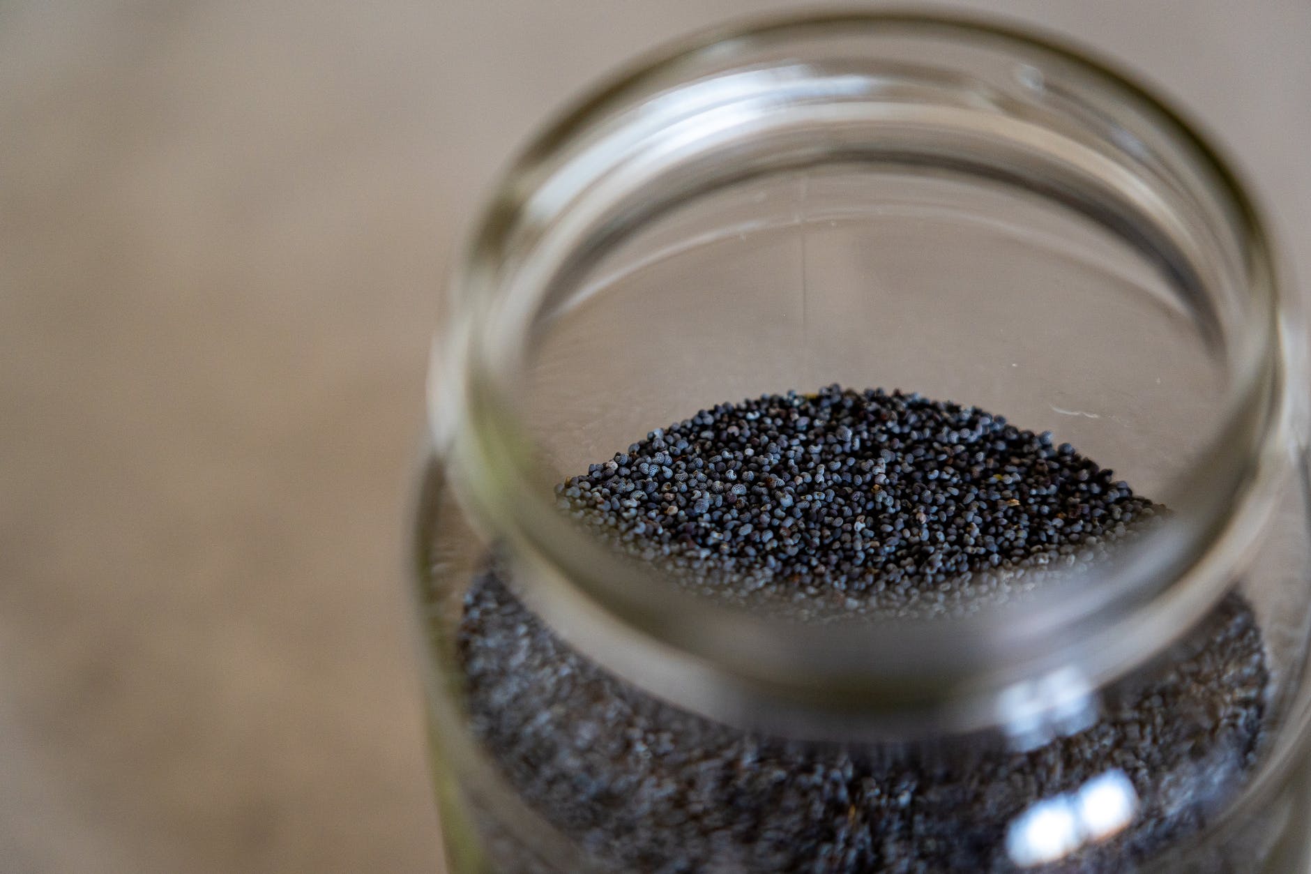 poppy seeds in clear glass jar