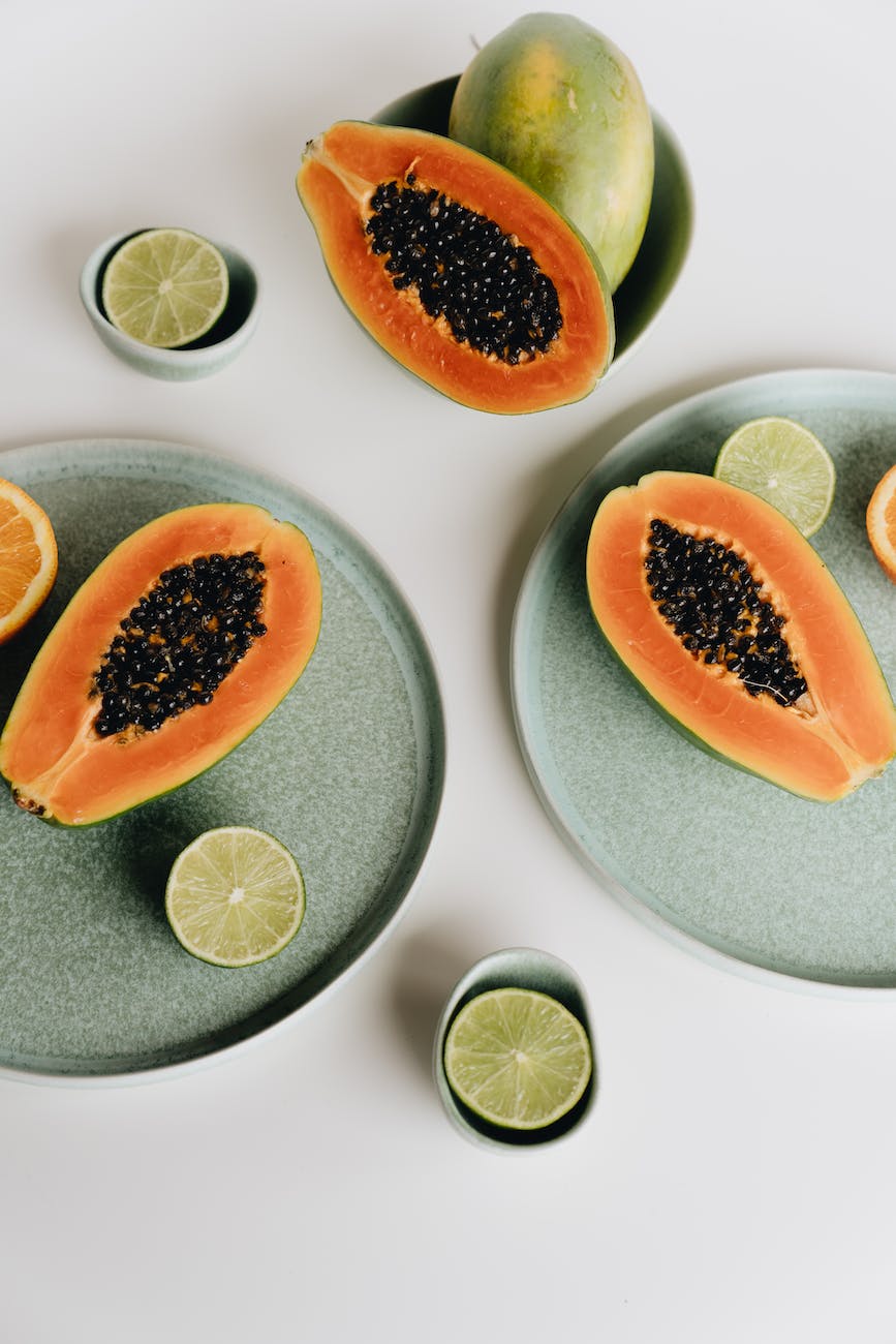 photo of sliced papaya beside sliced lime