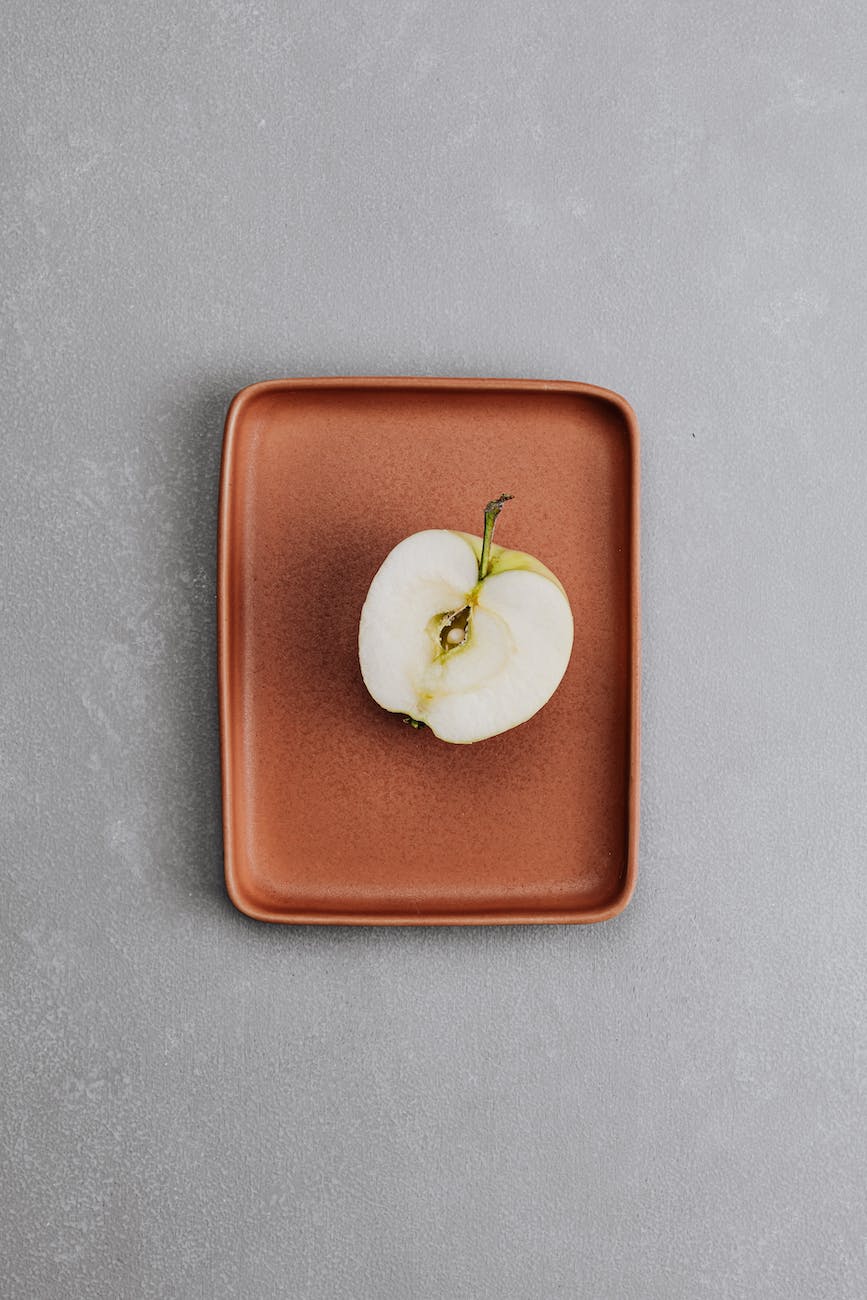 a sliced apple on a red tray