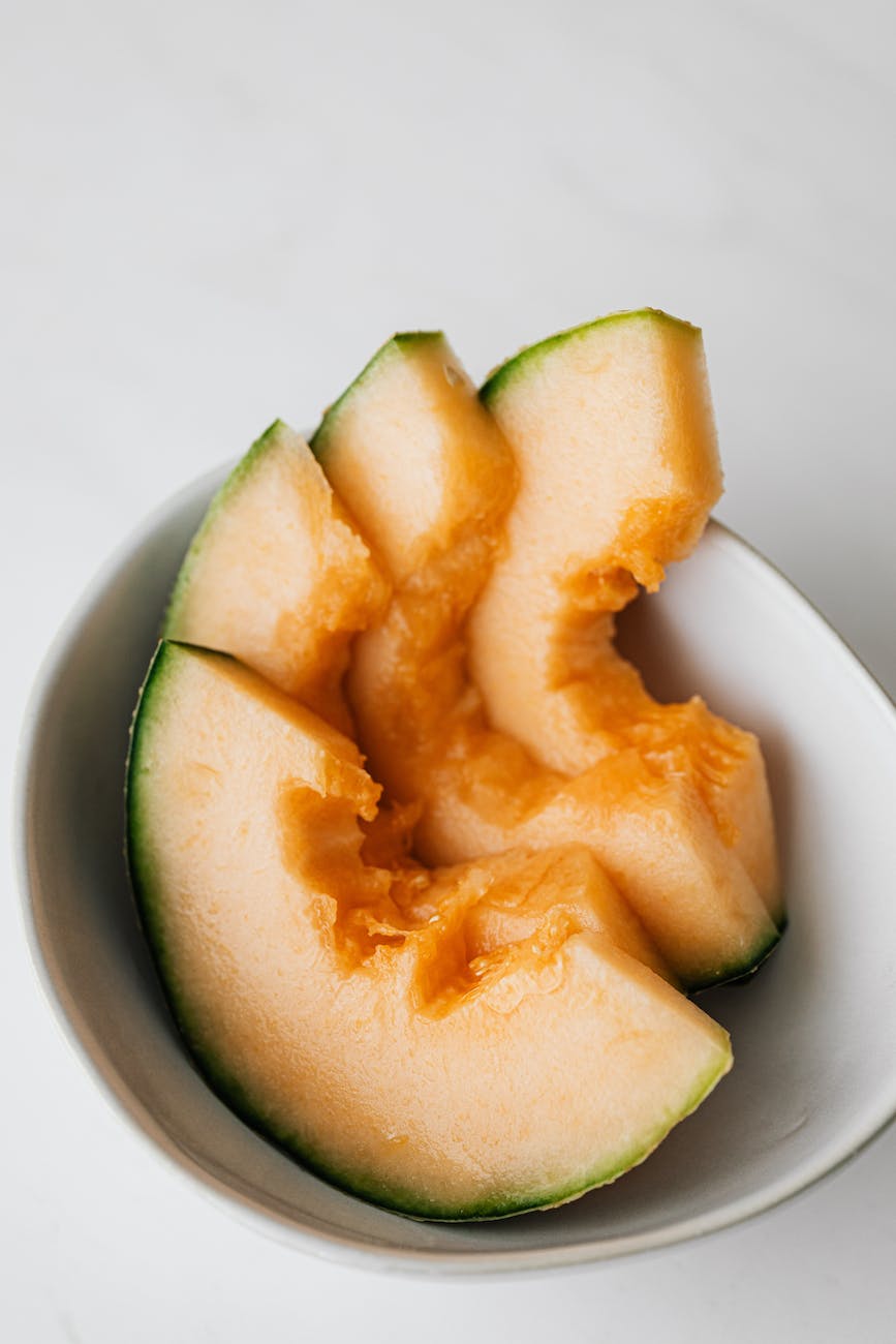 sweet healthy sliced melon in white bowl
